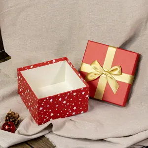 Red Christmas gift box with gold bow and star pattern, open box for holiday present packaging