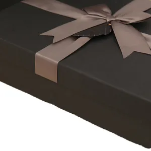 Luxury black rectangular gift box featuring satin ribbon bow for holiday and birthday party.