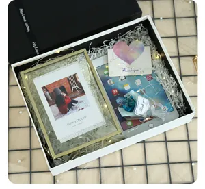 Exquisite gift box packaging set with shredded paper and fairy lights for special occasions.