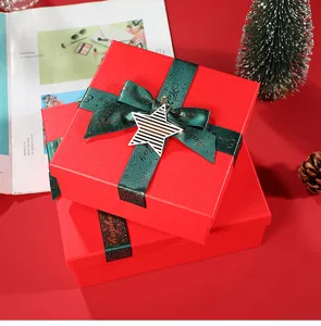 Red Christmas gift boxes with green glitter ribbon and star pendant, perfect for holiday packaging.