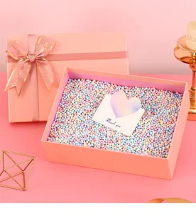 Pink gift box set with colorful foam filler balls and greeting card, ideal for birthdays and parties.