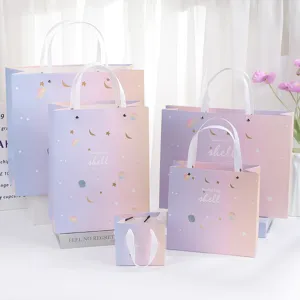Gradient paper gift bags with star shell design, assorted sizes for holiday gift packing.