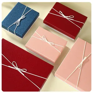 Detailed view of assorted gift boxes with white ribbon bows, premium packaging presentation.