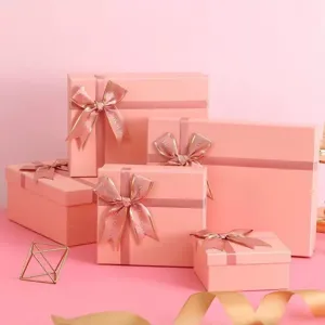 Elegant pink gift boxes set with ribbons, perfect for birthdays, weddings, and holiday presents.