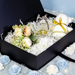 Black gift box set with artificial flowers, bear towel and perfume for Valentine's Day.