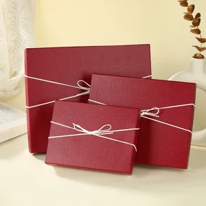 Red gift boxes set with white bow ribbon, decorative packaging boxes for jewelry and small items.