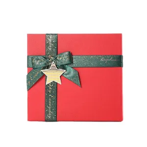 Red square gift box with green ribbon and star tag, perfect for Christmas and New Year presents.
