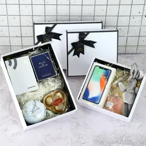Minimalist white gift box with black bow, elegant packaging for birthday and holiday presents.
