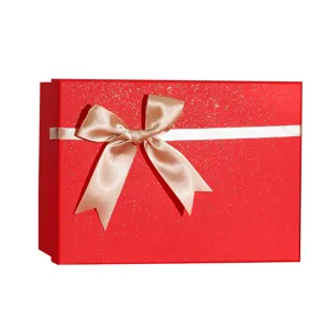 Red gift box with white ribbon and bow, elegant present packaging for holidays and parties.