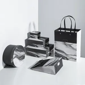 Black and white marble paper gift boxes set with portable bags for luxury packaging and presents.