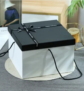 Detailed view of the premium black and white gift box featuring elegant ribbon and portable ropes.