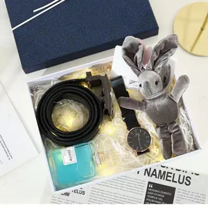 Luxury gift set box including leather belt, minimalist watch, perfume, and cute plush rabbit.