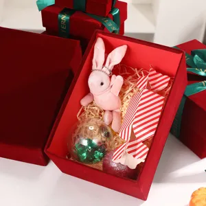 Christmas wine red gift box detail showing velvet texture and cute bunny toy inside for holiday.