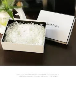 Exquisite white gift box with shredded paper, perfect for holiday gifts and romantic packaging.