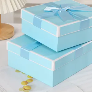Blue gift box detail close-up, premium cardboard packaging box with bow ribbon for presents.
