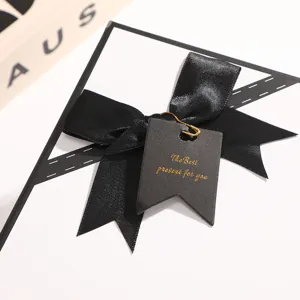 Elegant white gift box with black ribbon bow, perfect for boyfriend and holiday gifts.