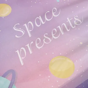 Close-up detail of a dreamy pink starry sky gift box with cute planet and galaxy graphics.