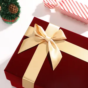 Christmas velvet bow gift box detail, premium red gift packaging for lipstick and perfume.