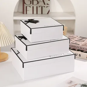 Luxury white gift boxes set with black ribbon bows, perfect for presents, weddings and parties.