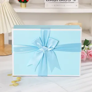 Light blue gift box with satin ribbon bow for cosmetics, scarf and birthday party packaging.
