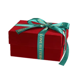 Burgundy velvet gift box with green ribbon bow for Christmas holiday packaging main view display