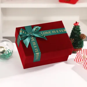 Red velvet gift box with green ribbon bow, elegant packaging for Christmas and wedding gifts.