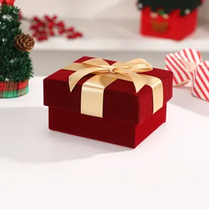 Red velvet gift box with gold ribbon for christmas present holiday party and packaging