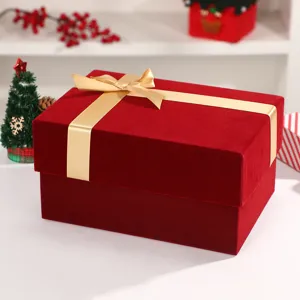 Red velvet gift box detail, festive Christmas design with golden ribbon bow for presents.