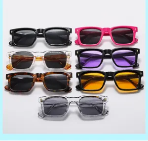 Close-up of trendy square sunglasses featuring thick frames and metal arrow accents.