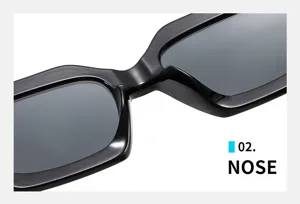 Detail view of modern polygon irregular small frame sunglasses, black glossy finish and dark lenses.