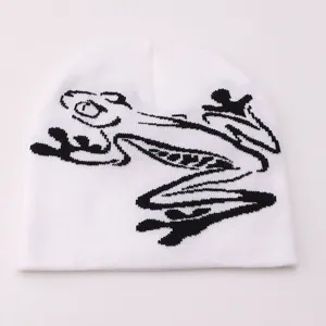 Casual white knit beanie with a stylish black frog jacquard design, warm and trendy.