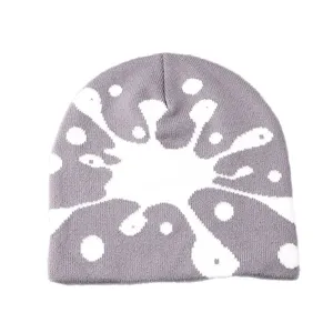 Grey knit beanie with white abstract paint splatter graffiti pattern, warm winter brimless cap.