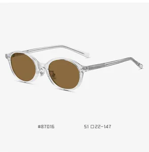 Trendy transparent frame oval sunglasses with brown lenses, stylish unisex vintage eyewear.
