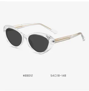 Clear frame cat eye sunglasses for women and men, stylish gold metal temple eyewear.