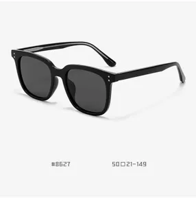 Detailed view of black thick-frame sunglasses, premium acetate design with metal rivet details.