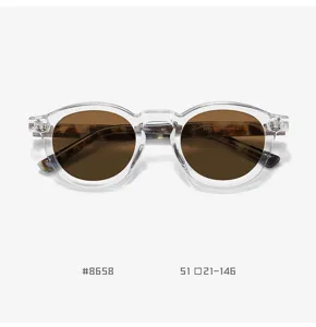 Detail view of retro clear TR90 round sunglasses with brown polarized lenses and temples.