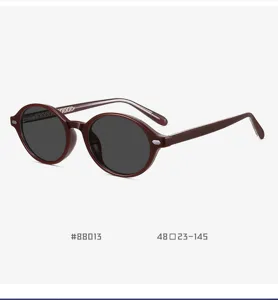 Detailed view of vintage oval TR90 polarized sunglasses showcasing maroon frame detail.