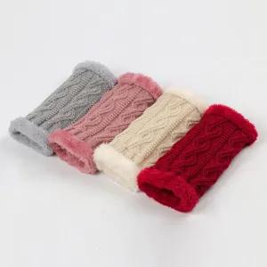 Close-up detail of knitted arm warmers, thick cable knit with soft fluffy plush cuffs.