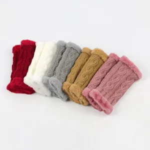 Close-up of cozy knitted arm warmers with plush lining and classic cable pattern details.