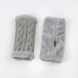 Grey knit fuzzy arm warmers detail shot showing intricate cable pattern and plush thumb hole design.