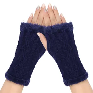 Close-up view of dark blue knit fingerless gloves with plush furry trim and diamond pattern.