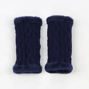 Close-up detail of dark blue knit arm warmers with cozy faux fur trim and classic cable pattern.