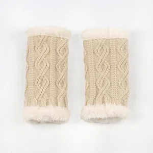 Detailed view of beige cable knit cuffs with plush faux fur trim, cozy winter warm arm accessories.