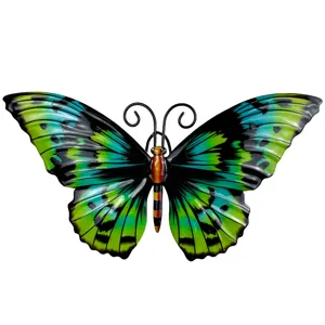 Metal butterfly wall art detail showing vibrant green and blue gradient wings and iron craft texture.