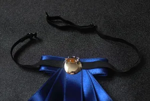 Close-up detail of blue satin ribbon bow tie with adjustable black strap and metal pin.