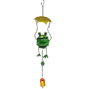Metal frog wind chime detail showing the cracked green glass ball body and hanging bell design.