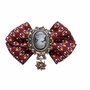 Vintage Victorian cameo bow tie brooch with rhinestone pendant, elegant fabric collar pin for women.