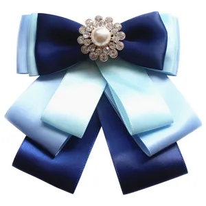 Elegant multi-layered blue ribbon bow tie with sparkling rhinestone pearl centerpiece for formal uniform.