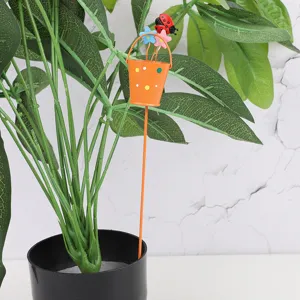 Metal plant stake garden insert detail showing cute orange bucket with ladybug and flowers decor.