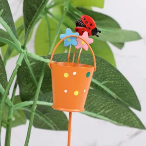 Metal garden stake with cute ladybug and flower bucket design, ideal for potted plant decor.